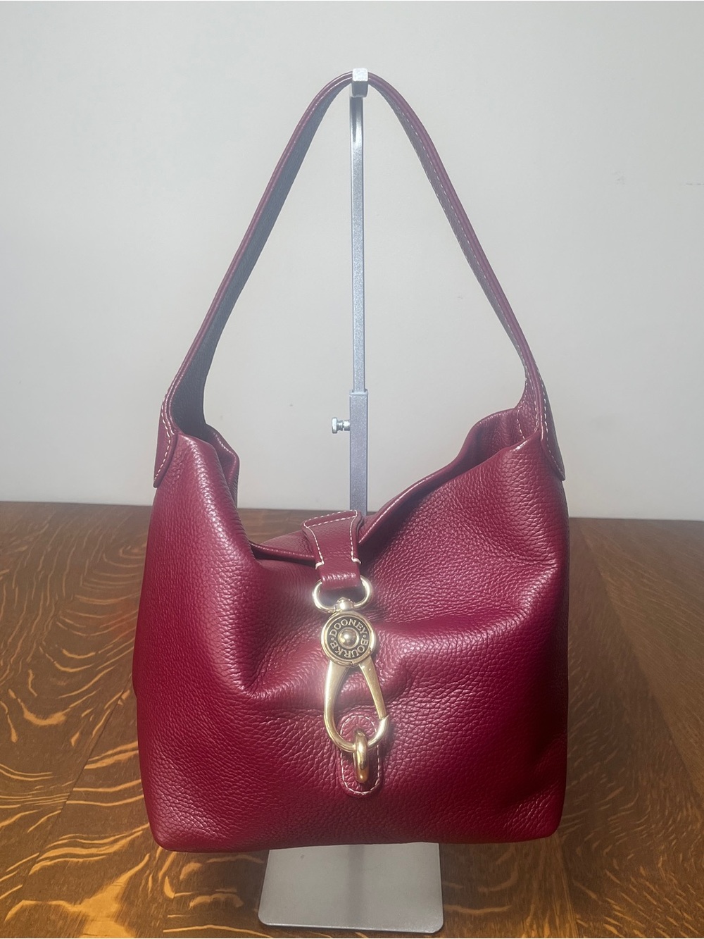 Dooney & Bourke Lucca Bordeaux Leather Shoulder Bag with Gold Logo Lock.